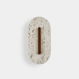 Olera travertine wall sconce with hand-carved stone body and integrated warm LED light, modern sculptural design