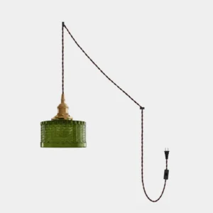 Olive green textured glass plug-in pendant light with chevron pattern and polished brass socket on white background
