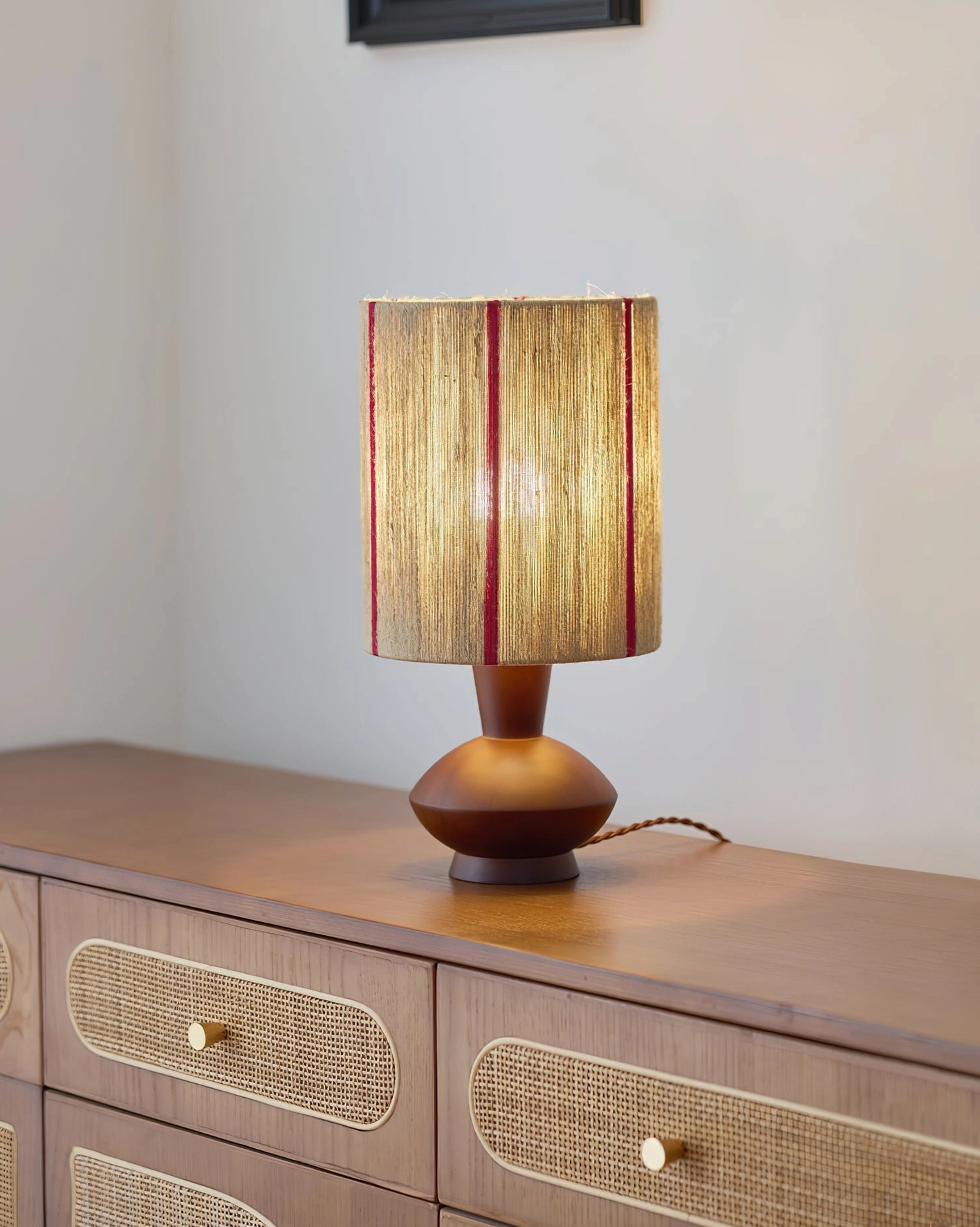 Onslow hand-wrapped lamp on bedroom dresser with natural warm lighting, low angle view
