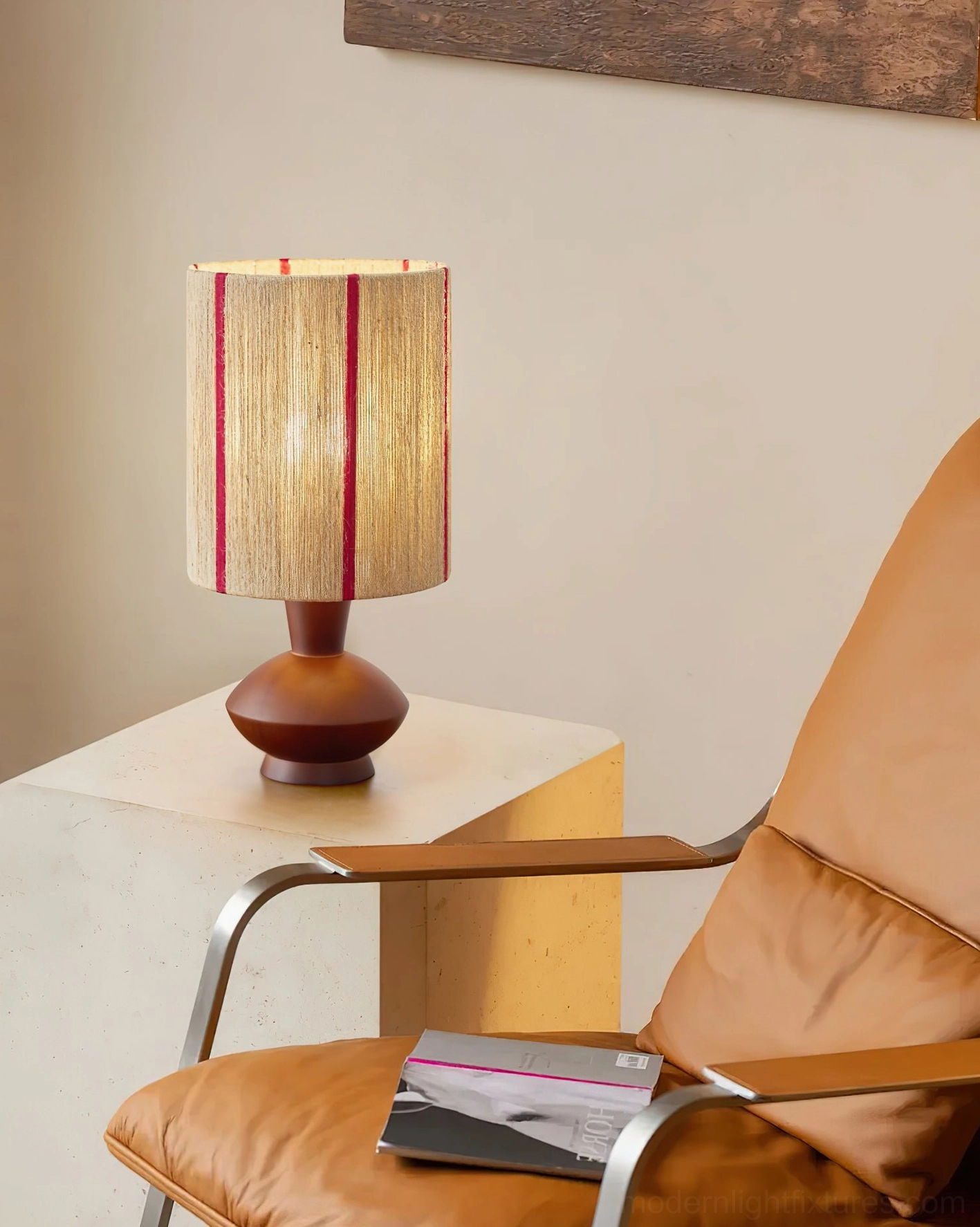 Onslow hand-wrapped rope lamp creating warm ambient light in modern living room with leather armchair