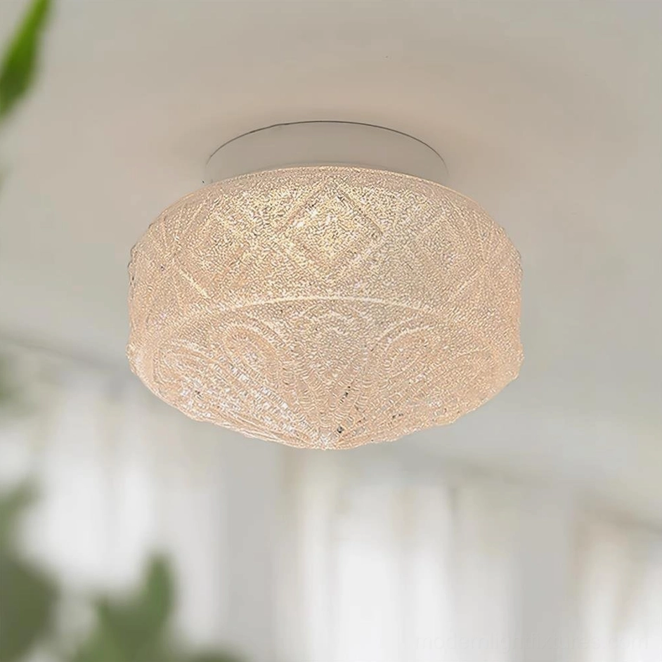 Vintage glass ceiling light fixture in opak frosted matte finish, showing carved embossed pattern and color variation