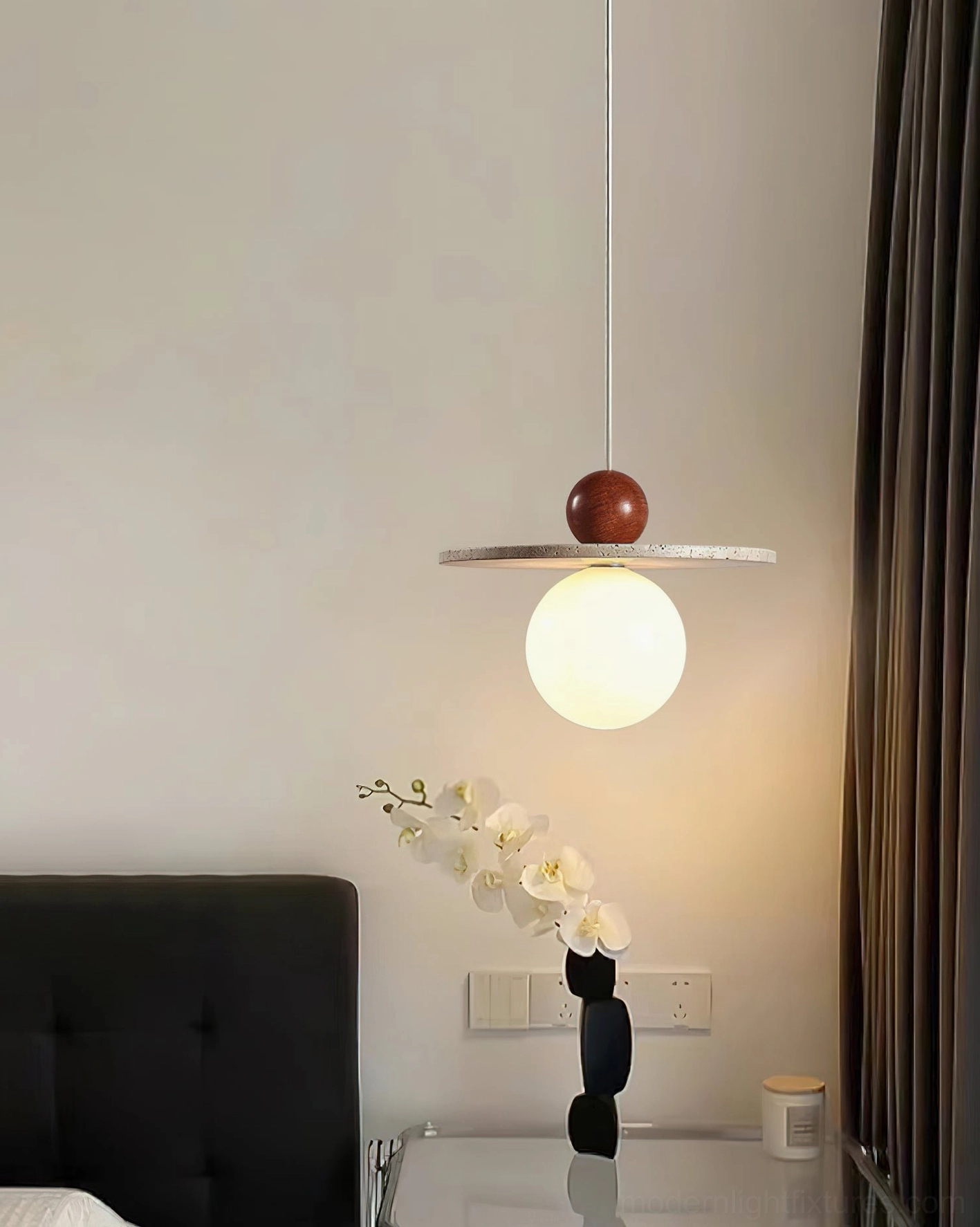 Ora pendant light installed above bedroom bedside table with warm ambient lighting
