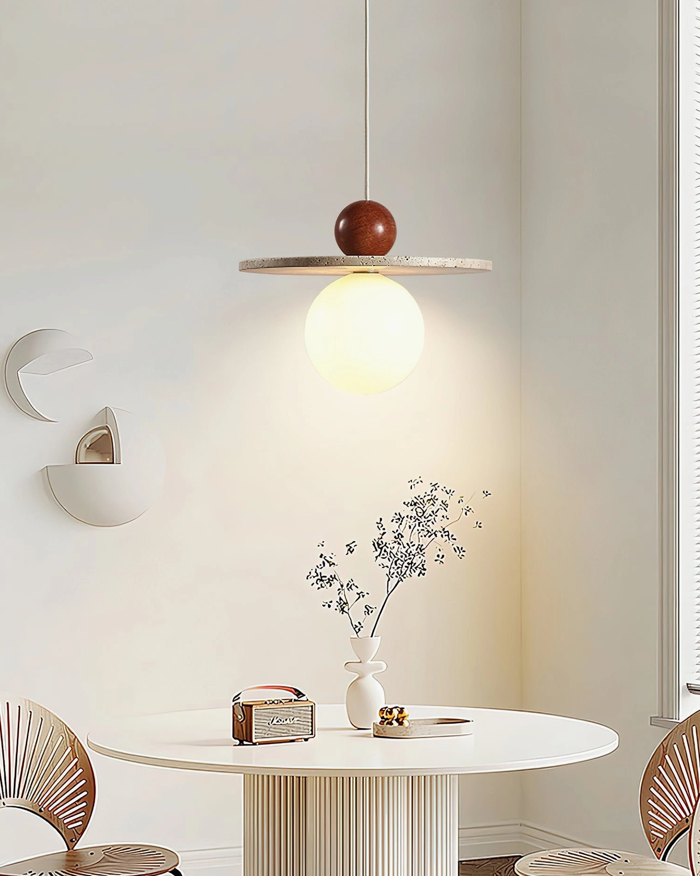 Ora pendant lamp suspended above dining table in contemporary apartment interior