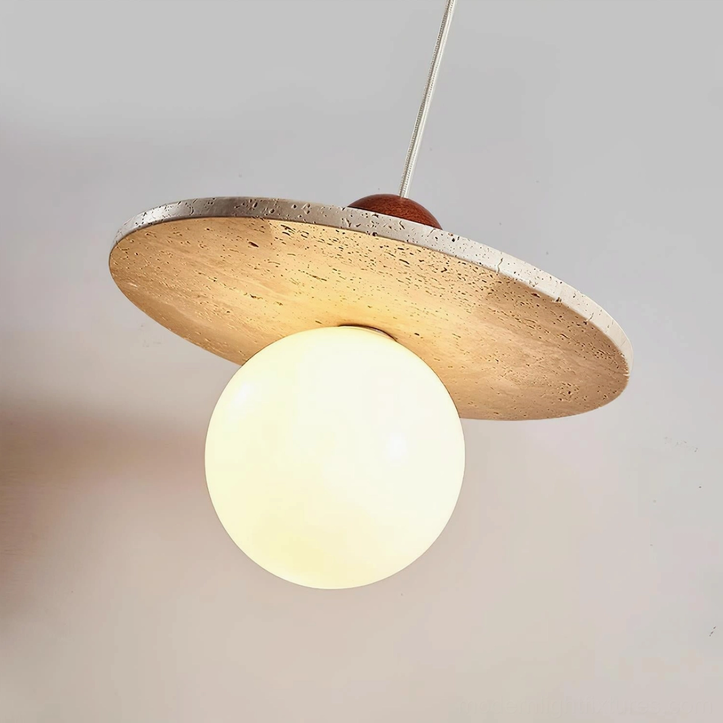 Ora globe pendant with travertine texture in modern home environment