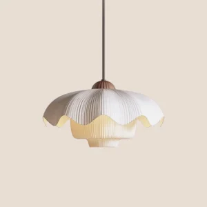 Close-up front view of Orabella pendant light showing hand-pleated layered fabric shade and wooden-tone metal cap