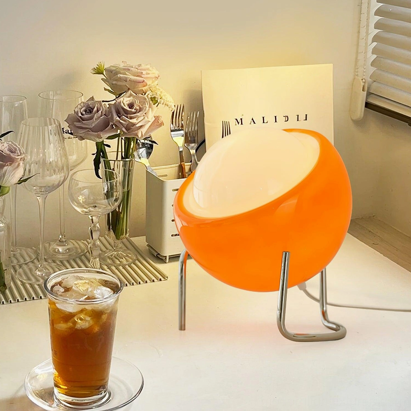 Orange dome table lamp modern mid-century design with tilted glass shade and sculptural metal legs