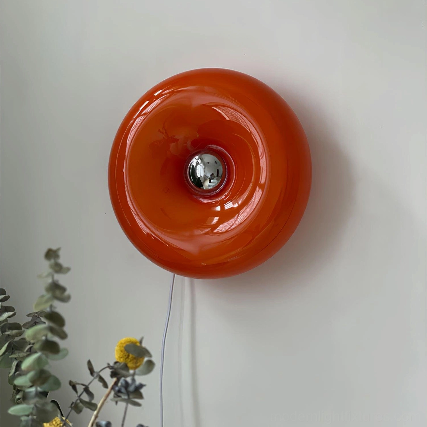 Orange donut wall light showing sculptural beauty and warm nostalgic illumination design