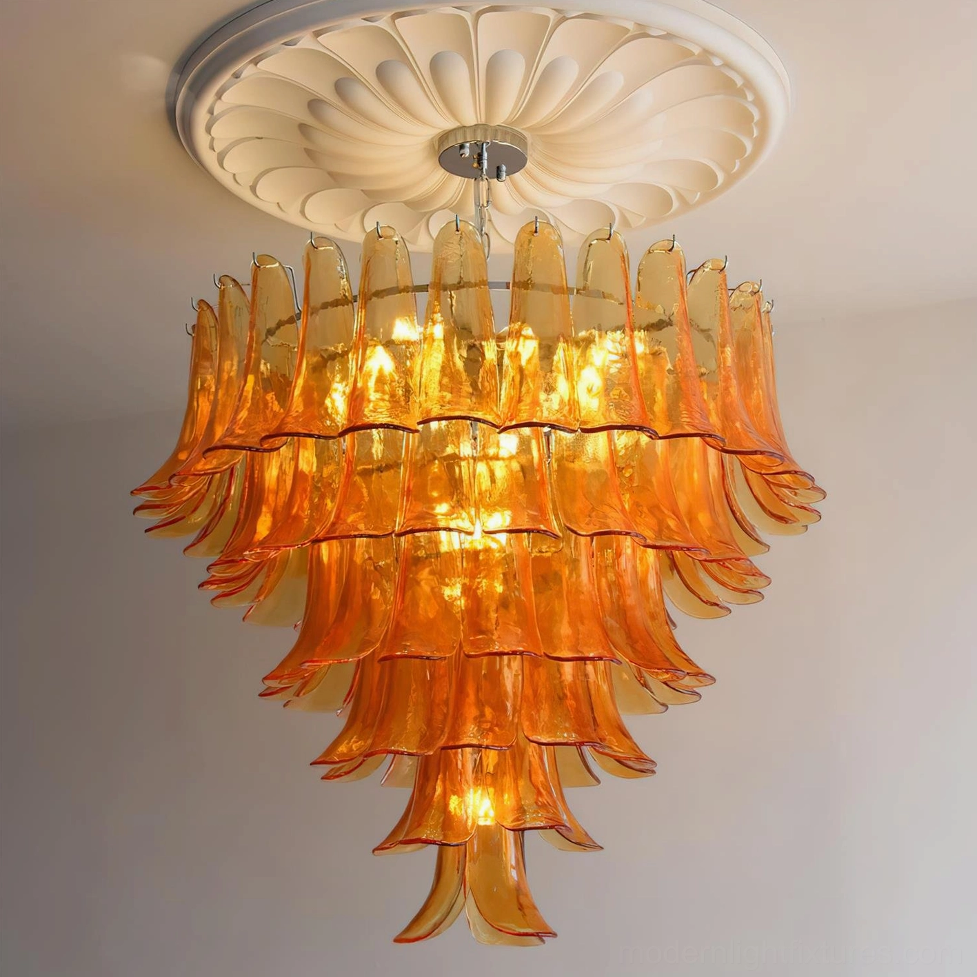 Orange gradient Murano glass petal chandelier with decorative ceiling medallion and green plants