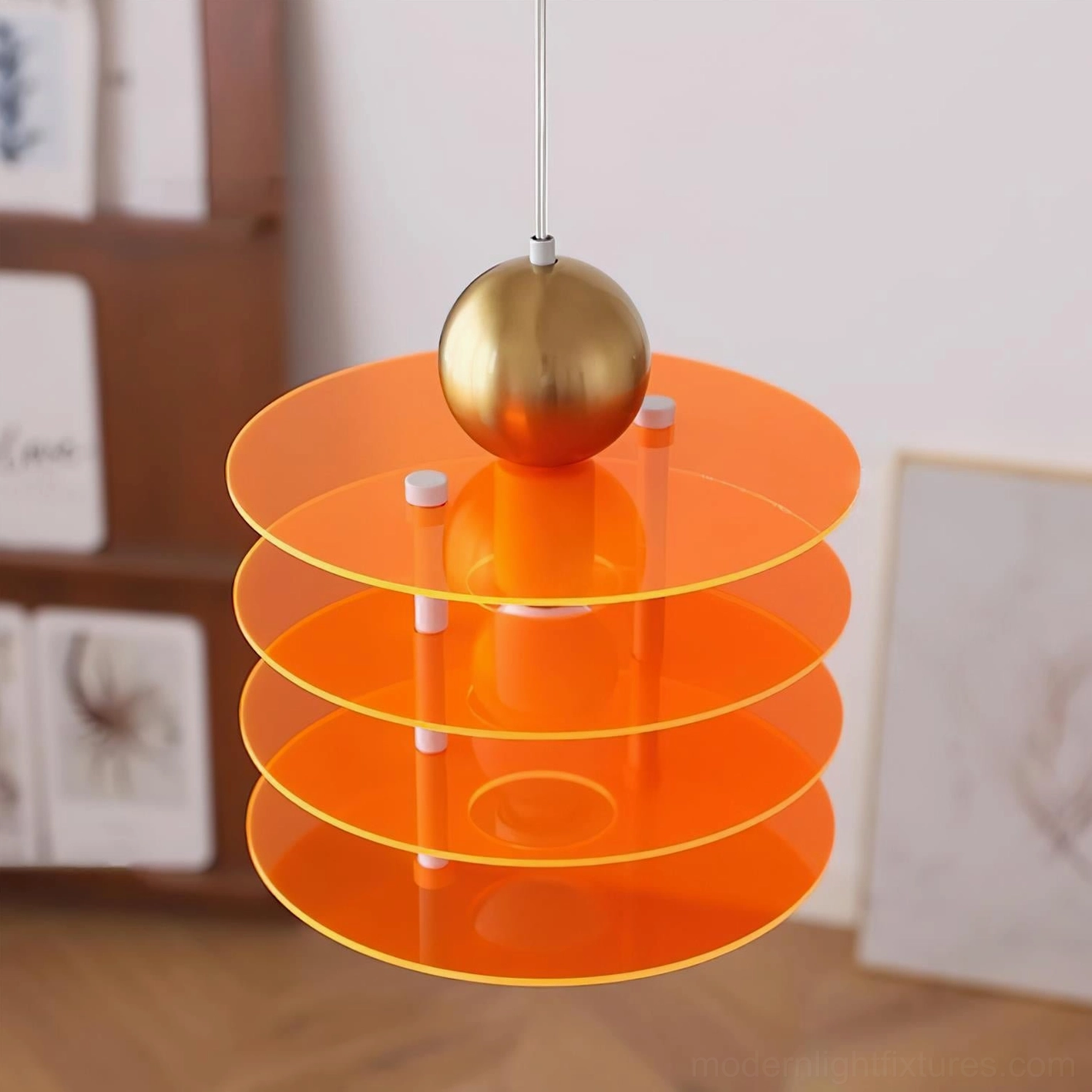 Orange and gold layered disc pendant light with modern minimalist design