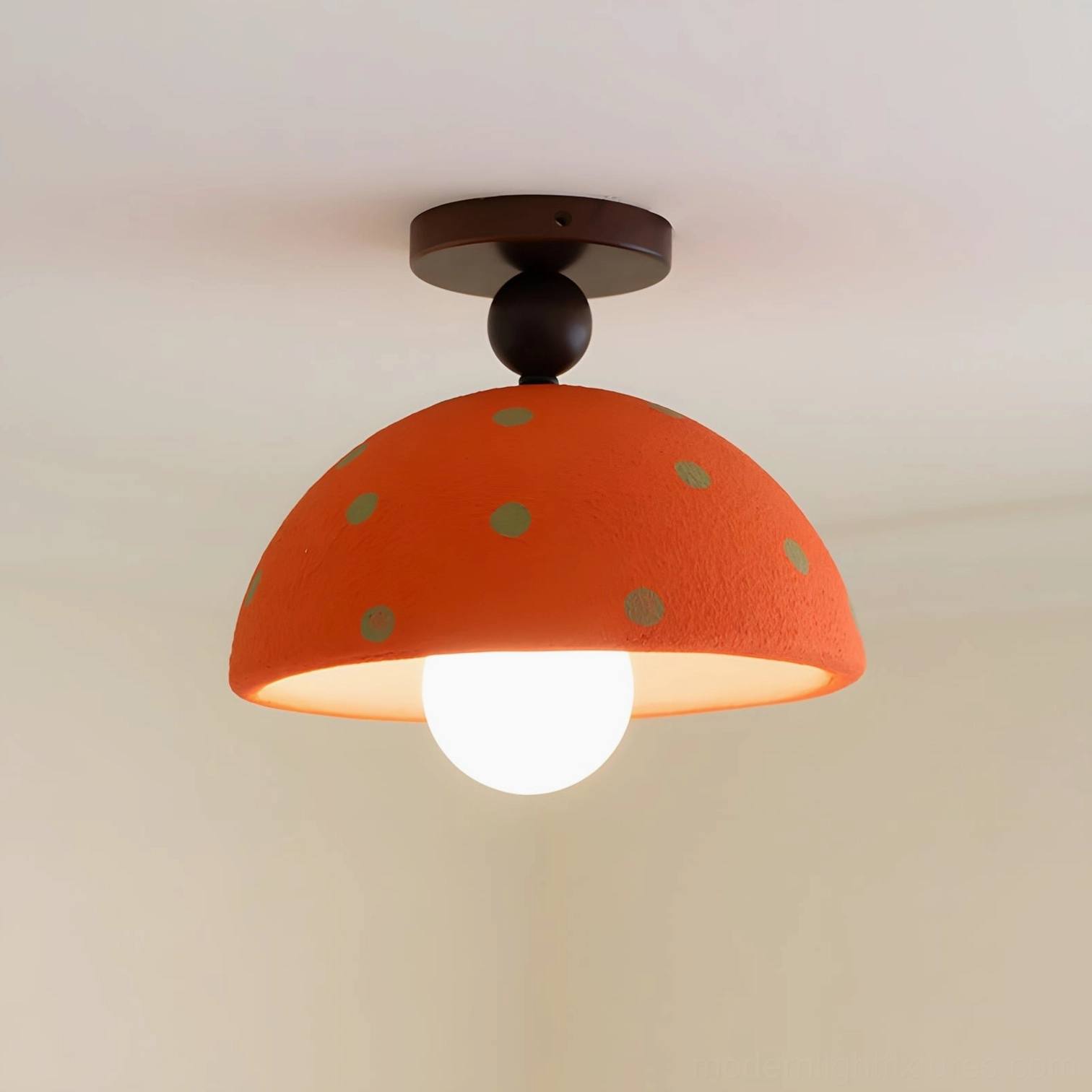 Orange dome ceiling light with gray polka dots in studio close-up showing hand-applied details