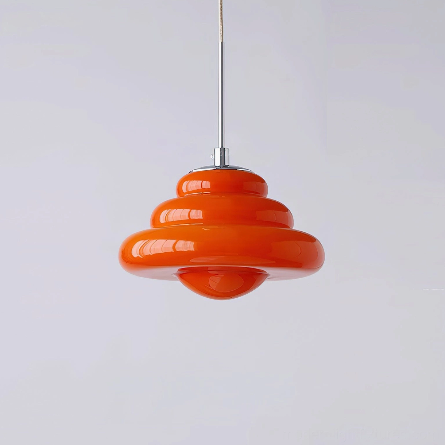 Bright warm orange tiered glass pendant light, mid-century modern design, direct front perspective