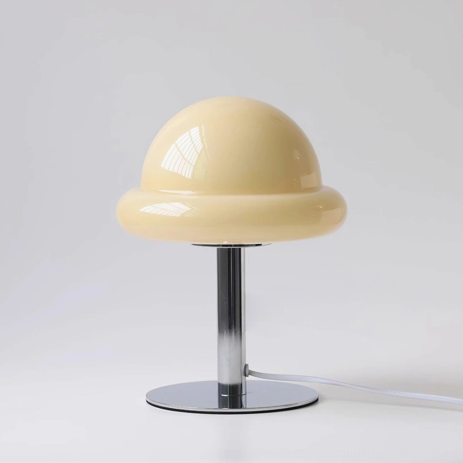 Orange mushroom glass table lamp creating warm glow in contemporary interior setting