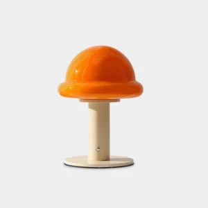 Orange mushroom rechargeable table lamp with smooth glossy shade and light wood-toned metal stand, front view on white background