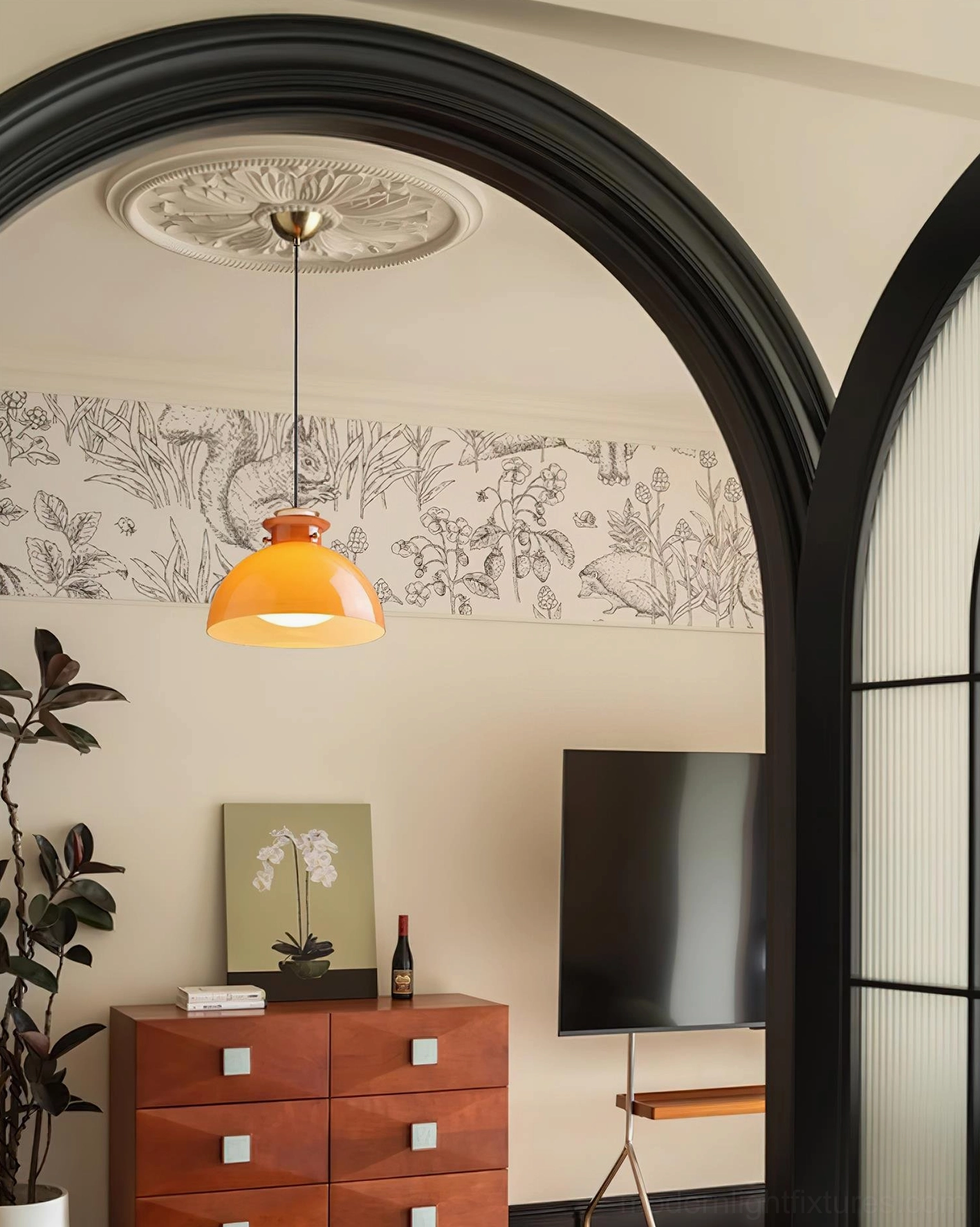 Modern orange glass pendant fixture with adjustable wire length for various ceiling heights