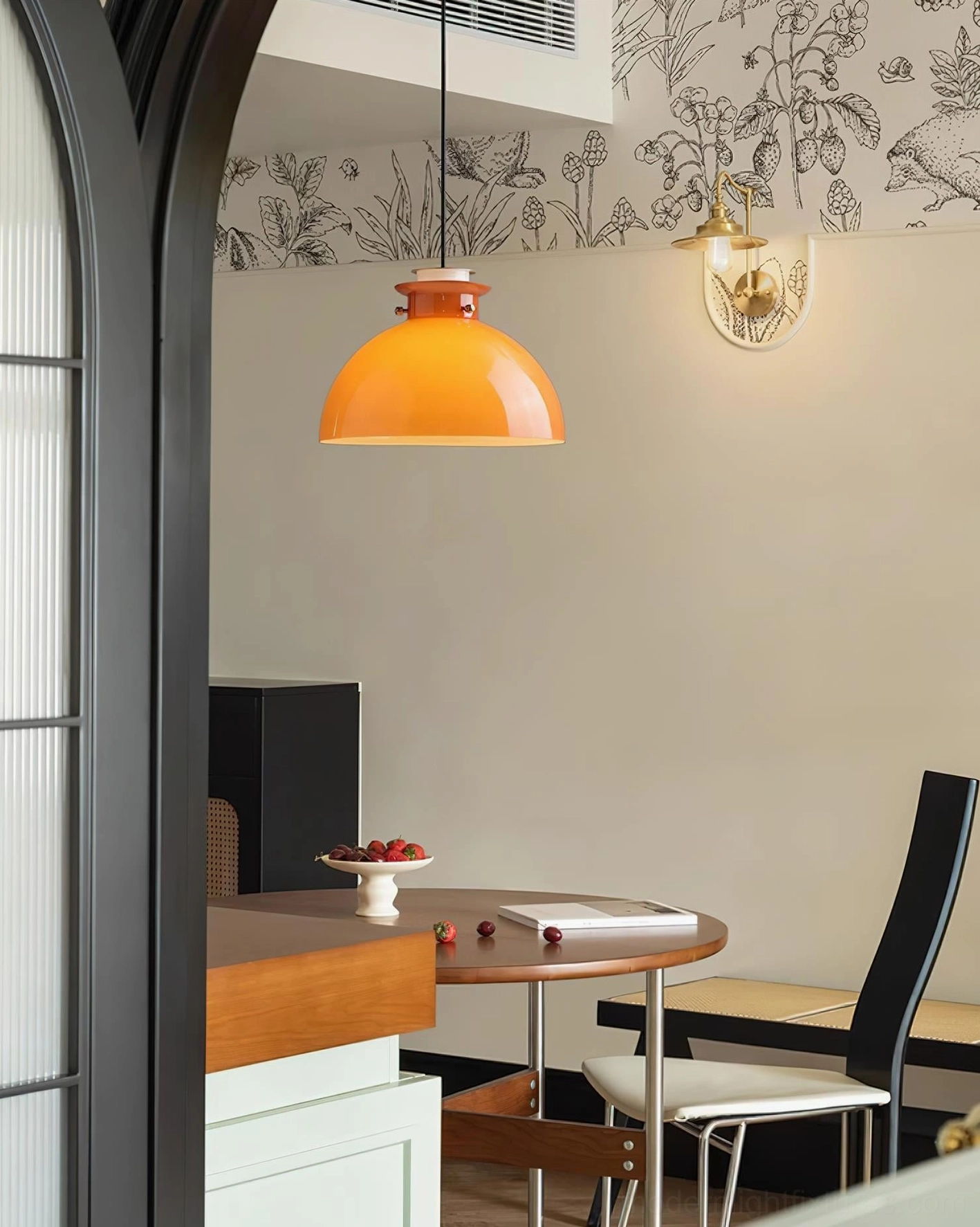 Orange dome pendant light in contemporary interior setting with neutral background