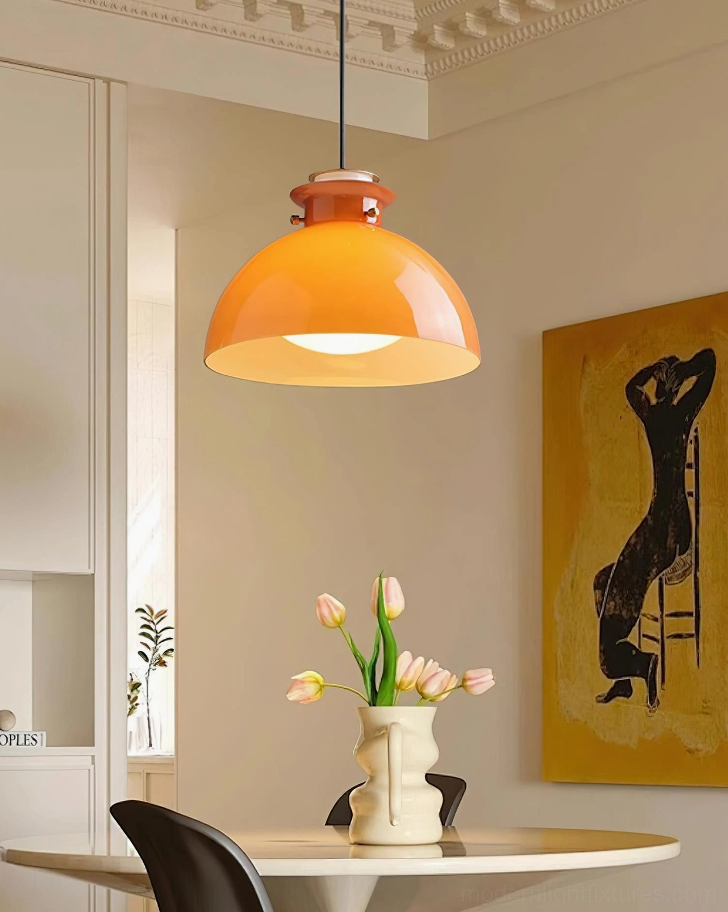 Orange dome pendant light hanging in residential dining kitchen with warm retro decor