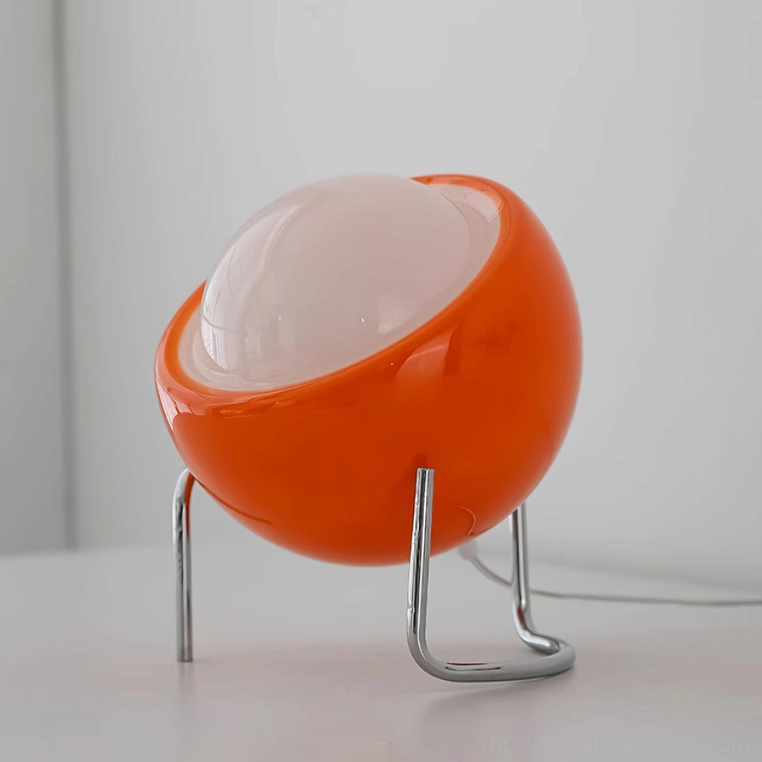 Orange red Bauhaus dome table lamp with chrome curved tripod stand, product showcase view
