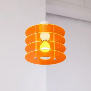 Orange tiered disc pendant lamp with exposed bulbs in minimalist interior setting