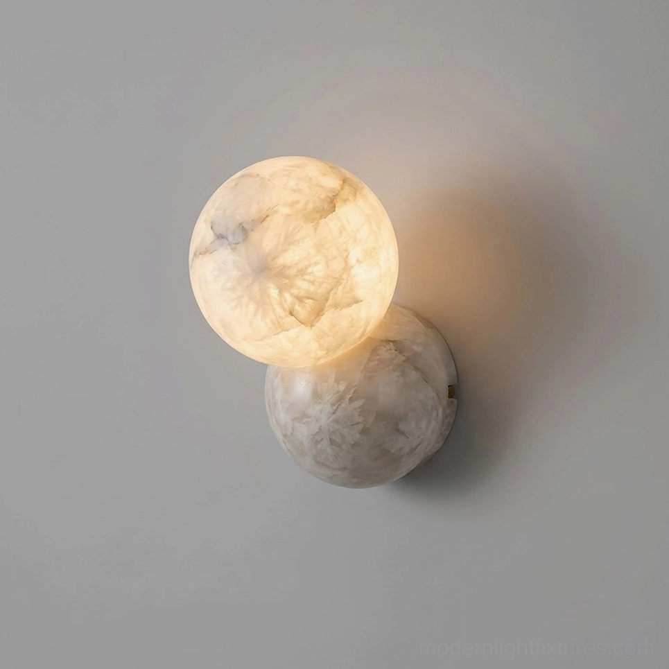 Orb Alabaster Wall Sconce close-up side view showing warm glowing light through translucent alabaster stone spheres with natural veining