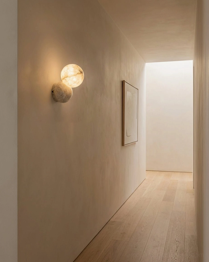 Single Orb Alabaster Wall Sconce mounted in residential hallway creating warm ambient lighting accent