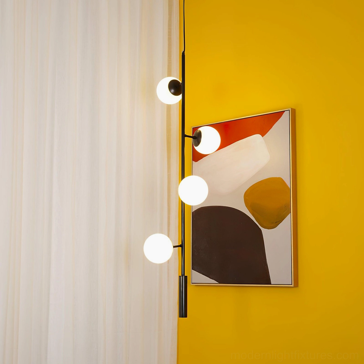 Contemporary orb chandelier installed overhead in minimalist dining or living space
