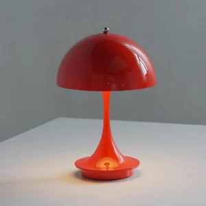 Red Orbee table lamp with polished acrylic finish and chrome metal base, three-quarter view with illuminated LED