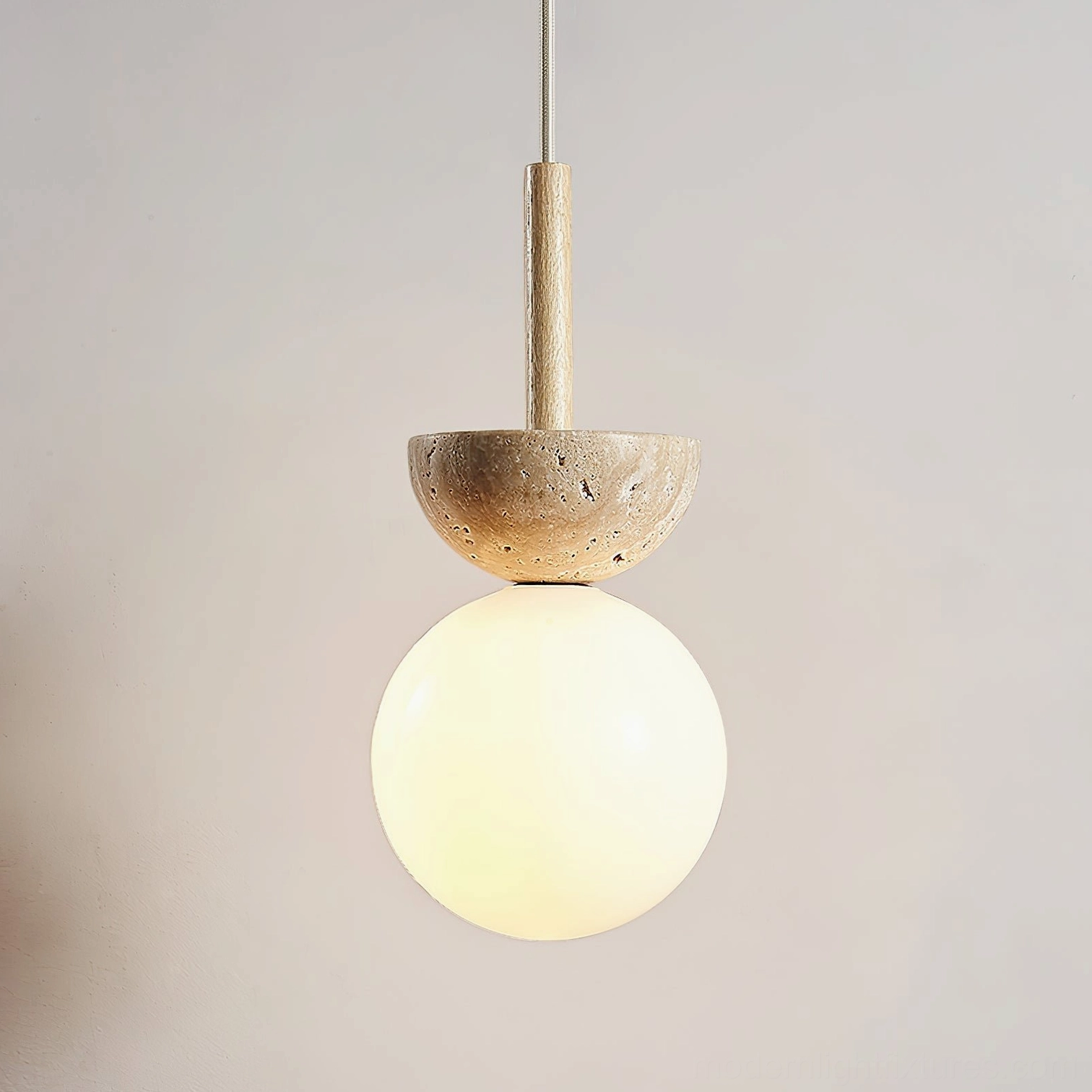 Orbis pendant fixture side angle view, travertine stone bowl cap wooden suspension