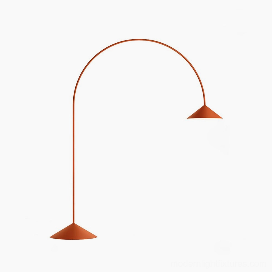 Orange Orbitas arc floor lamp creating bold color statement in minimalist modern interior space