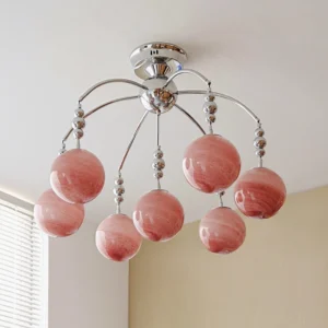 Orbola semi-flush pink globe chandelier in residential setting with window blinds and chrome metal frame