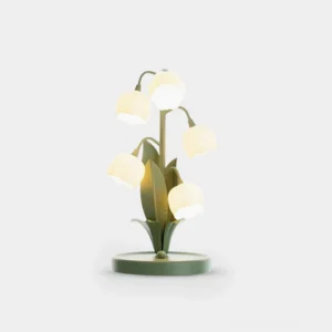 Sara Orchid floral table lamp with sage green metal stem and soft glowing white flower petals on white studio background