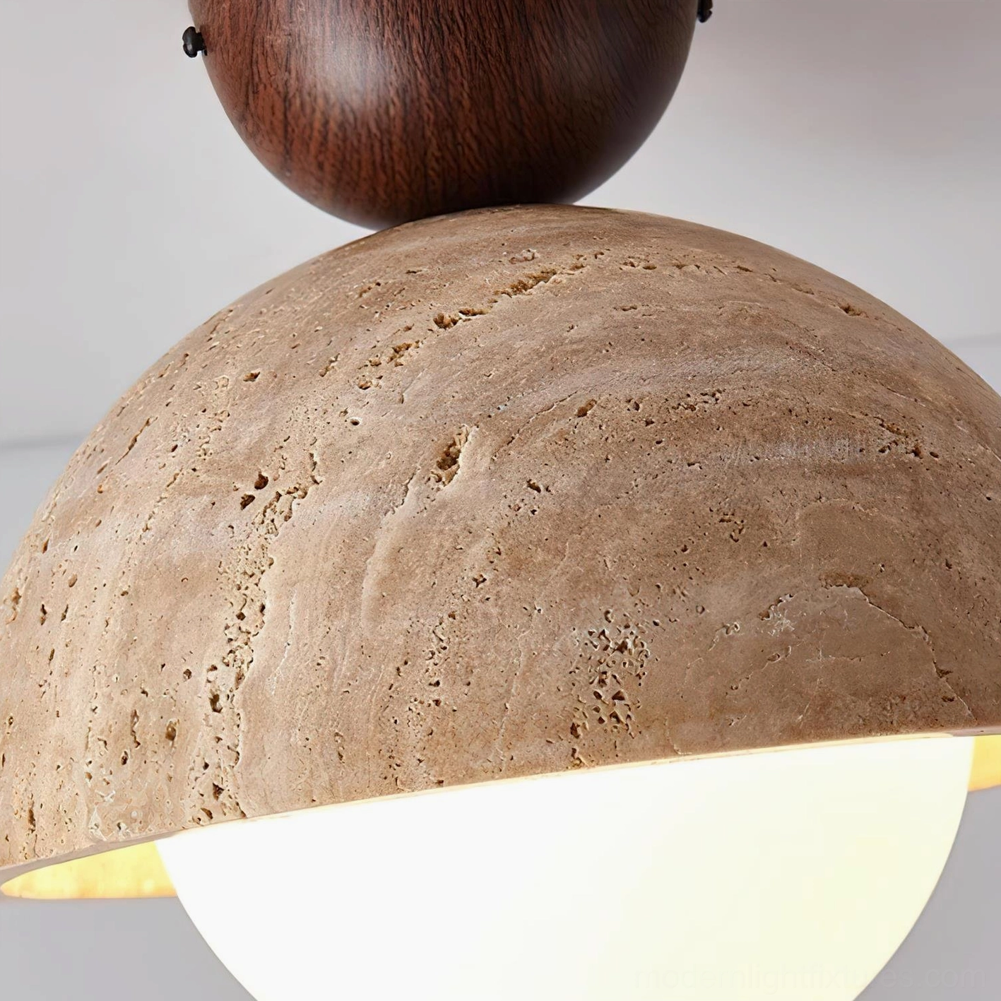 Orella travertine ceiling light fixture close-up showing frosted milky glass globe and warm light diffusion quality