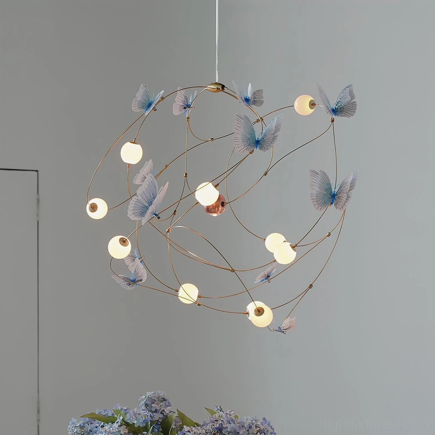 Modern chandelier with organic butterfly motif brass framework and integrated warm white LED for atmospheric home lighting
