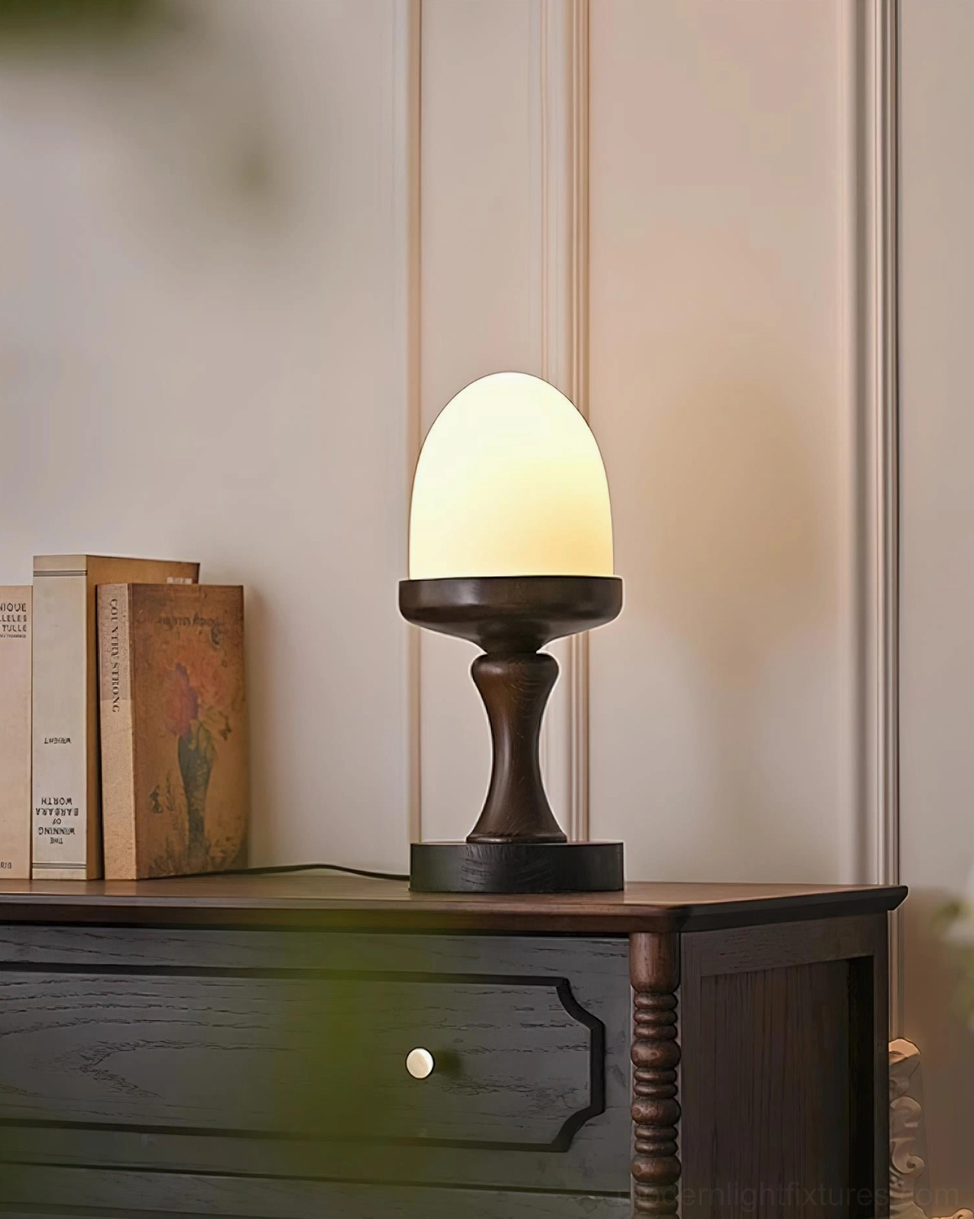 Illuminated biophilic table lamp in farmhouse setting with green plants and console table, side view