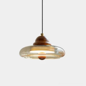 Oria mid-century modern pendant light with amber glass shade and walnut wood fixture, front overhead studio view