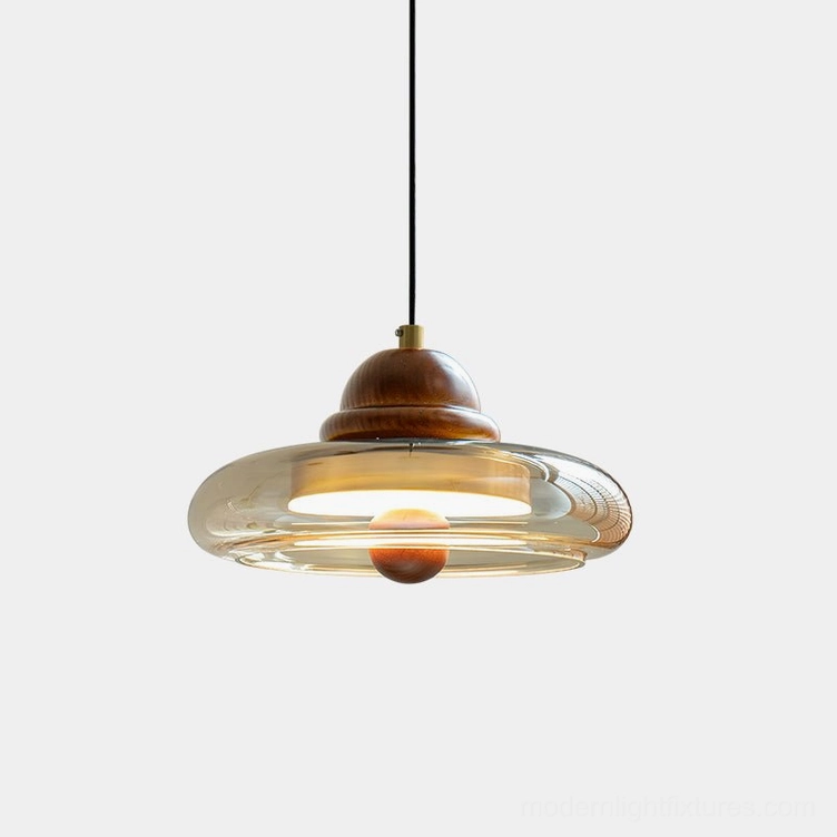 Oria mid-century modern pendant light with amber glass shade and walnut wood fixture, front overhead studio view