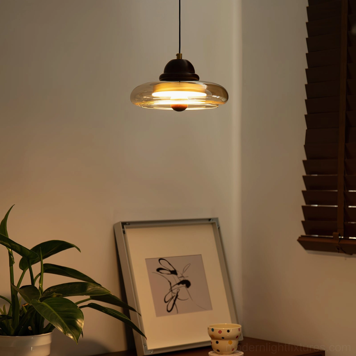 Oria mid-century modern pendant lamp hanging in bedroom with retro style and ambient lighting