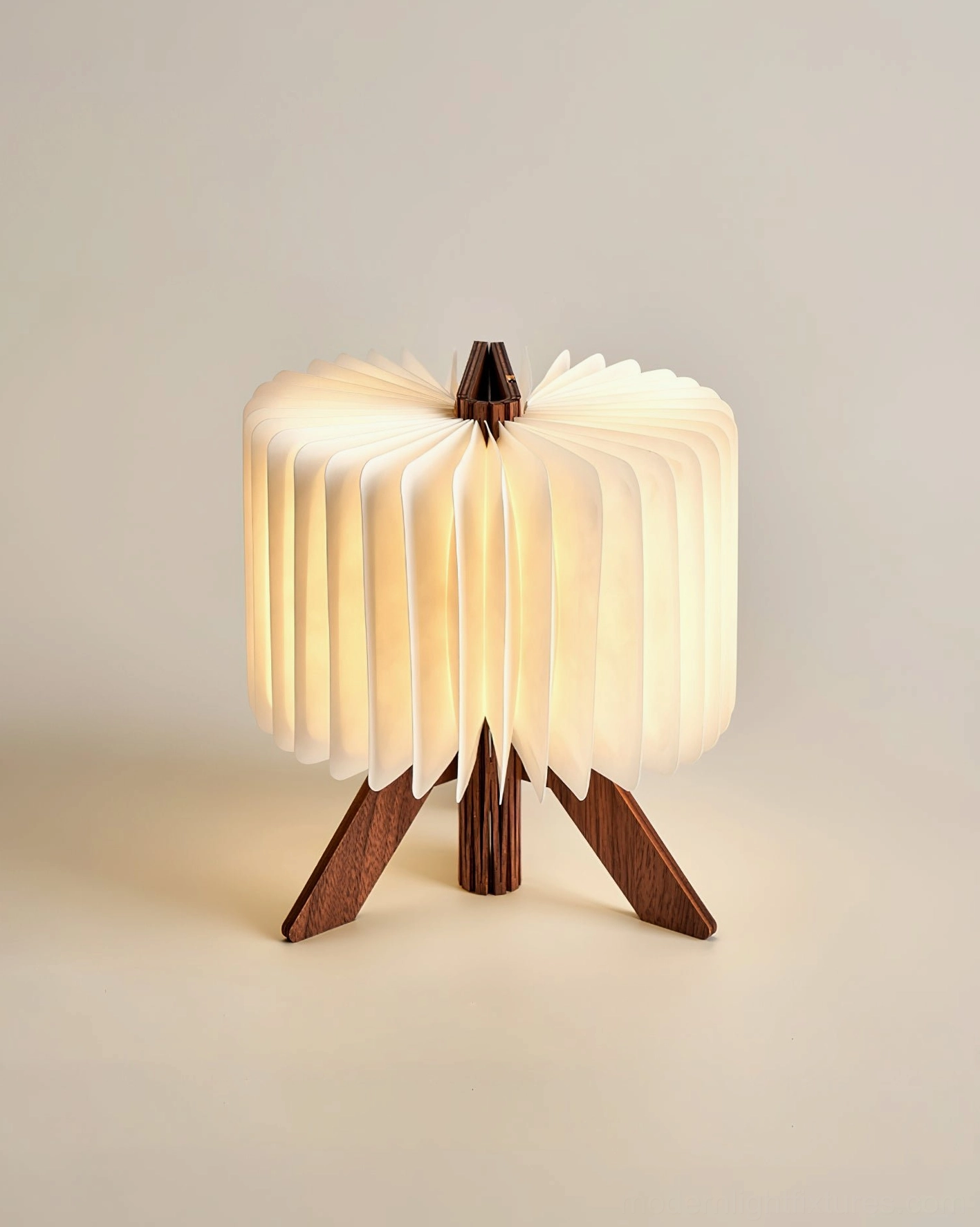 Origami folding table lamp with solid wood base and pleated fabric shade, warm neutral studio background