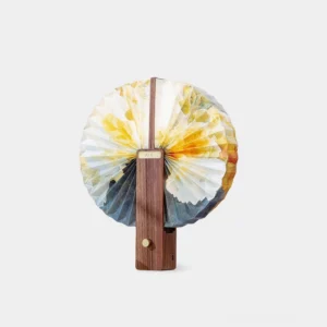 Origami folding fan paper table lamp with walnut wood base and watercolor floral shade, studio front view on white background