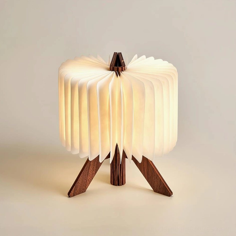 Three-quarter view of pleated DuPont paper shade and walnut wooden triangular base, modern folding design