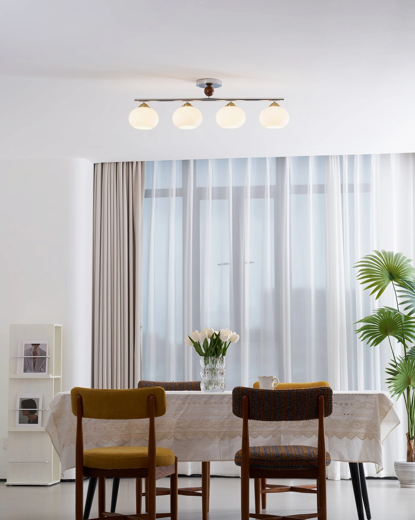 Orley 4-globe linear glass ceiling fixture in contemporary home setting with warm glow