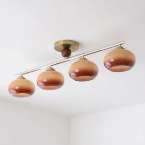 Three-quarter side view of Orley ceiling light showing gradient brown glass globes and metal mounting rod
