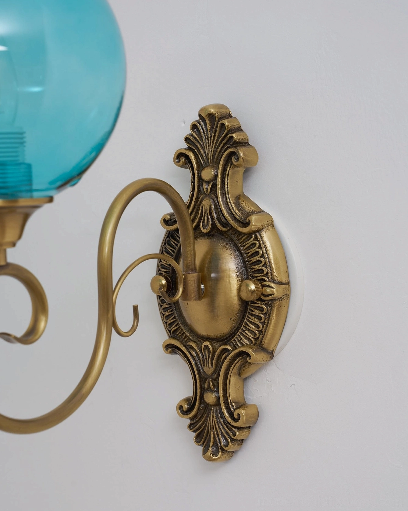 Ornate brass wall sconce curved arm and glass globe assembly, vintage lighting component