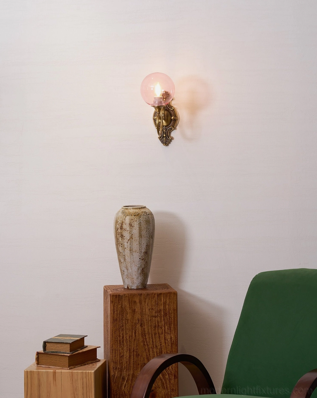 Ornate brass wall sconce with frosted glass globe, soft diffused vintage lighting effect