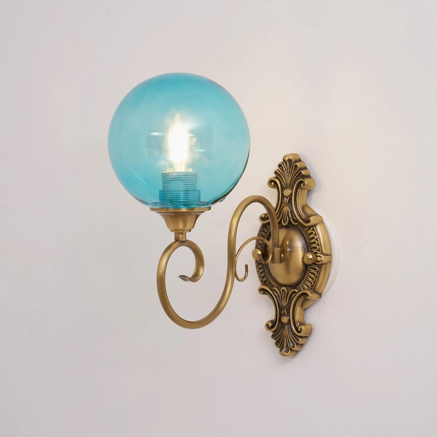 Ornate brass wall sconce showing electrical socket and mounting hardware, E14 vintage fixture