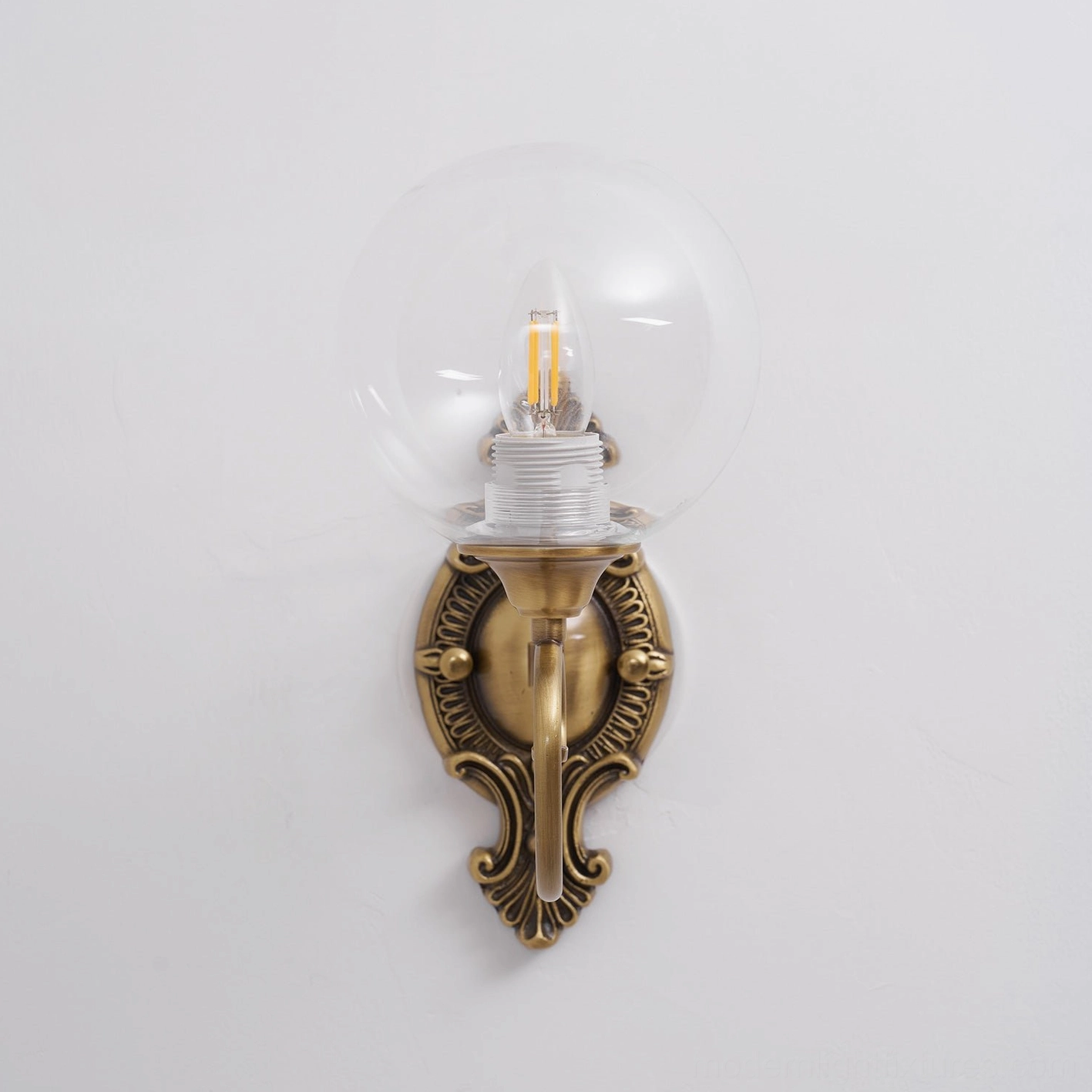 Ornate brass wall sconce backplate detail, classical baroque metalwork craftsmanship