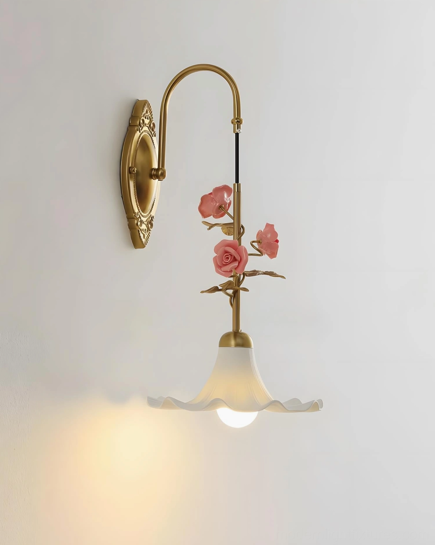 Ornella botanical wall sconce three-quarter view with warm glowing light in ruffled frosted glass shade