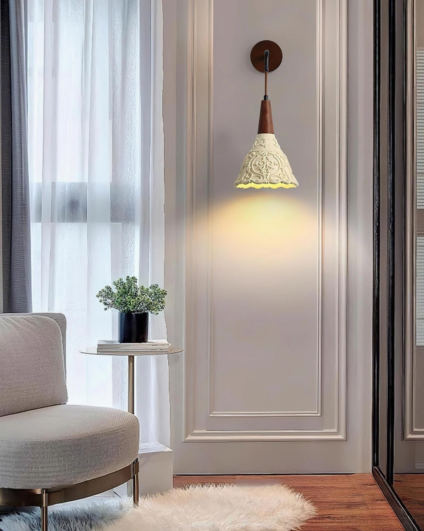 Ornella wall sconce in minimalist living room, soft warm glow from carved ivory shade complementing light modern home decor