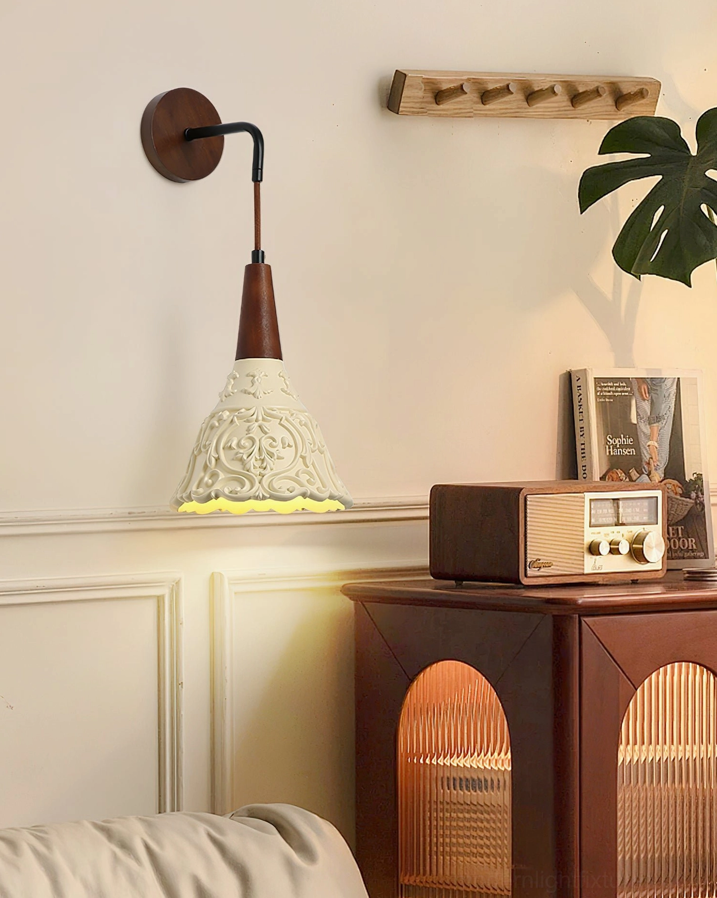 Ornella carved wall sconce in lounge setting, vintage home decor, demonstrating soft warm glow and artistic carved details