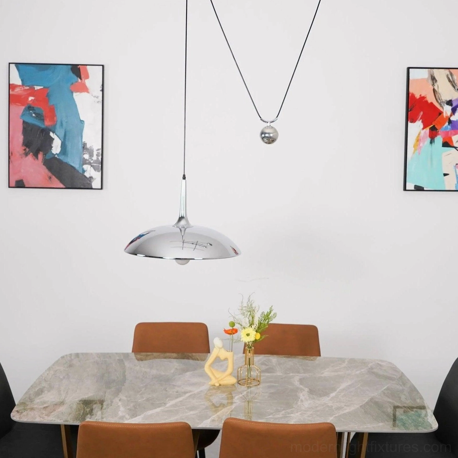 Contemporary dining room with Oscar pendant light fixture installed above marble table showcasing minimalist aesthetic