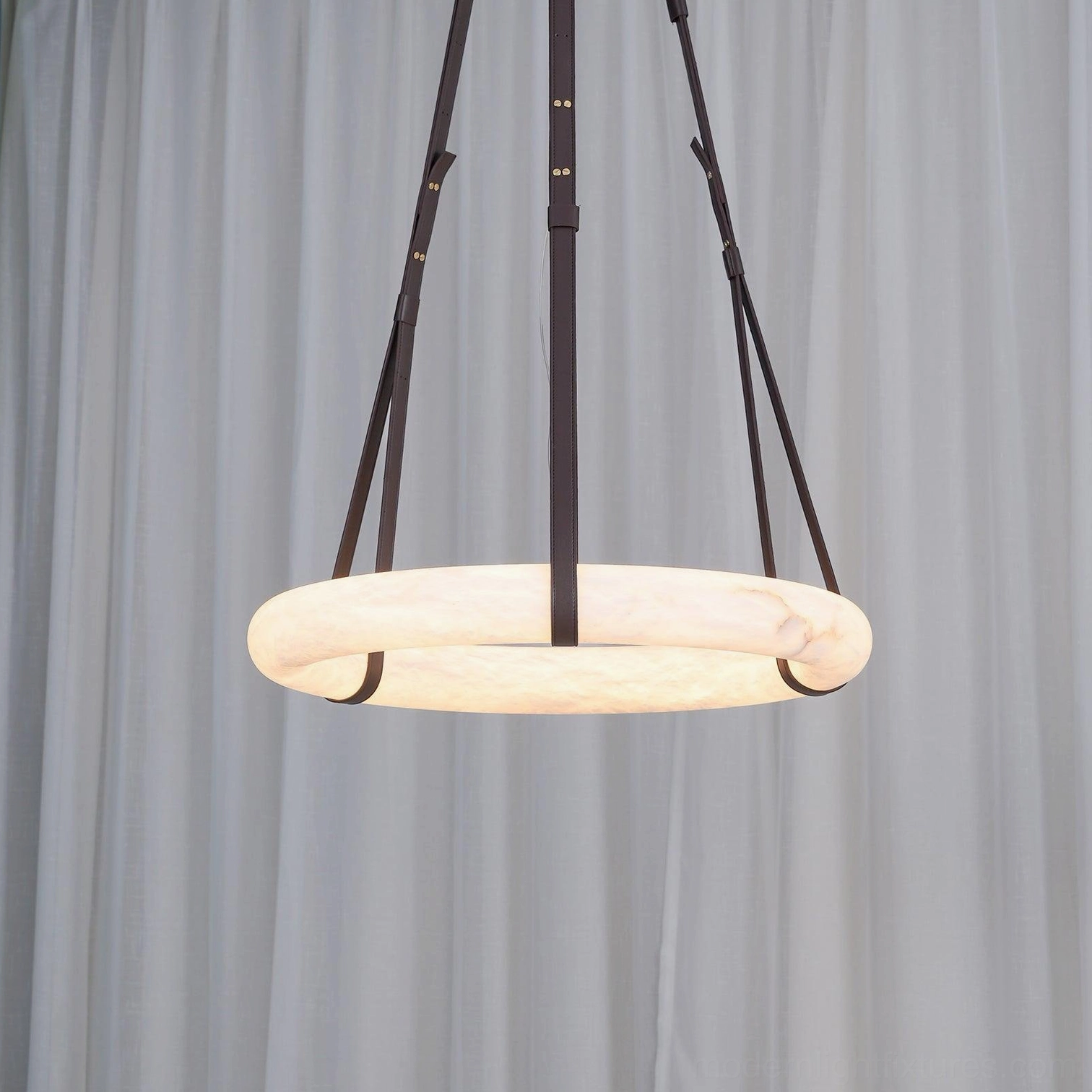 Top-down overhead view of Oslo alabaster ring pendant showing single central leather suspension cord and white sheer curtains